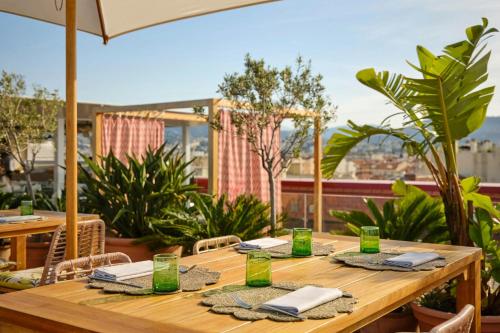 a wooden table with napkins on top of a patio at AC Hotel by Marriott Nice in Nice