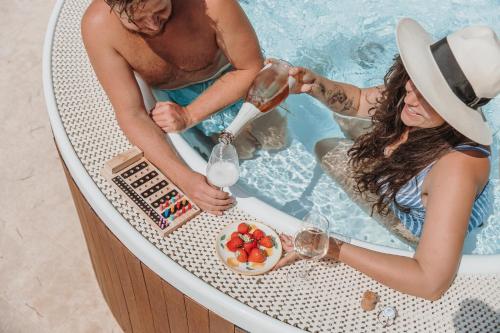 two women in a bath tub in a swimming pool at Maniero Montecassiano in Montecassiano