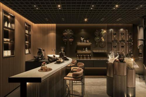 a kitchen with a counter and stools in a room at Sankara Nairobi, Autograph Collection in Nairobi
