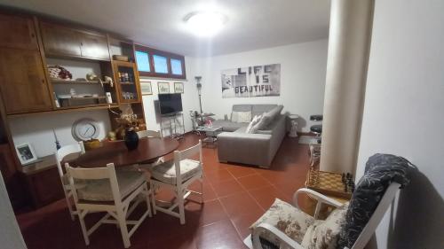 a living room with a table and a couch at L'Ulivo, alloggio in seminterrato in Fornello