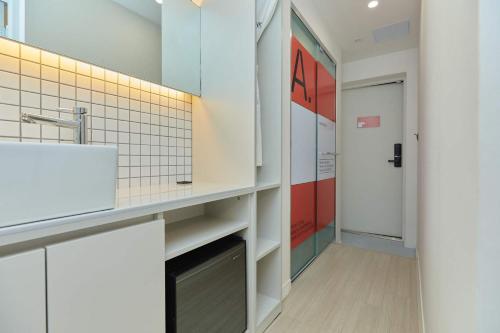 a bathroom with a sink and a mirror at Aank Hotel Seoul Sinchon in Seoul