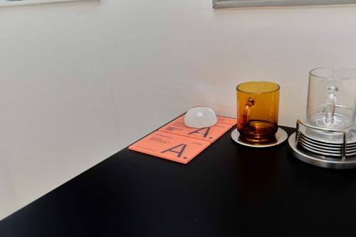 a table with a glass and a coaster and plates at Aank Hotel Seoul Sinchon in Seoul