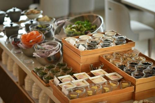 a table topped with wooden boxes filled with different types of donuts at IRAPH SUI, a Luxury Collection Hotel, Miyako Okinawa in Miyako Island