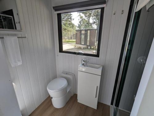 a small bathroom with a toilet and a window at Tiny Homes Escape at Grampians Edge by Tiny Away in Dadswells Bridge
