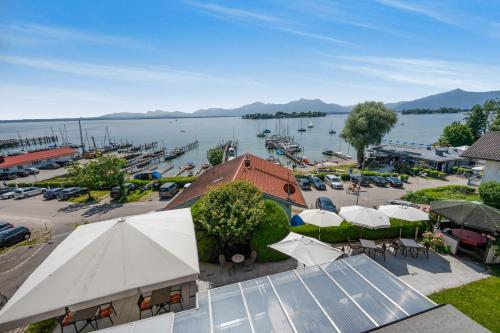 an aerial view of a marina with tables and umbrellas at ChiemseeStern Vacation & Recreation "Adults Only" in Gstadt am Chiemsee