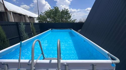 a swimming pool with blue water in a backyard at Art House in Yerevan