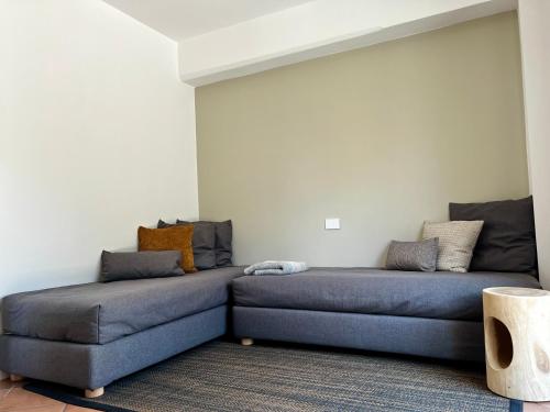 a room with two beds and a couch at APPARTAMENTO I SENTIERI 29D in Dro