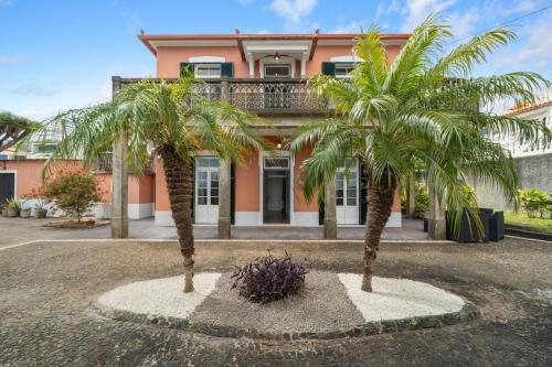 two palm trees in front of a house at Akosuah's Villa in Funchal