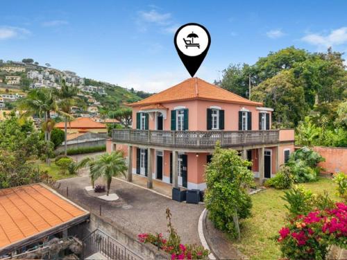 a house with a sign on top of it at Akosuah's Villa in Funchal