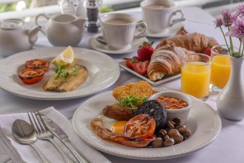 a breakfast table with two plates of breakfast foods at The Beachcroft Hotel, BW Signature Collection in Bognor Regis