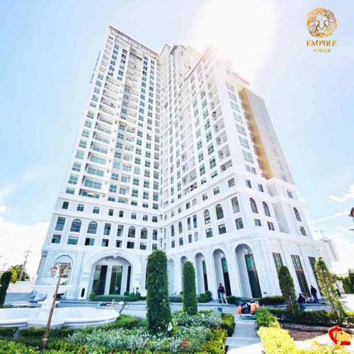 a large white building with a large at The Empire Tower Pattaya in Jomtien Beach