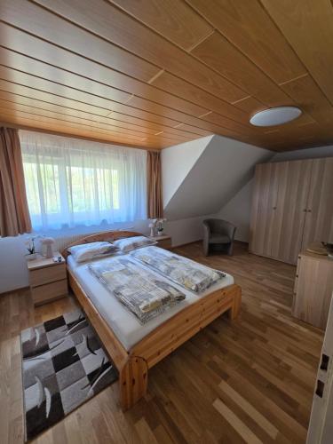 a bedroom with a large bed with a wooden ceiling at Hirsch Panorama in Bad Wildbad