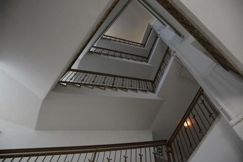 a staircase in a building with a white ceiling at Hotel Aquila in Scoppito