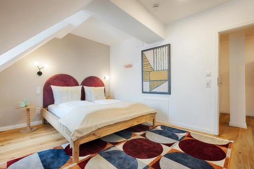 a bedroom with a bed and a rug at homie stay Dominikus in Würzburg