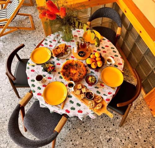 a table with a plate of food on it at Our Old House in Tʼelavi