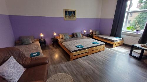 a bedroom with a bed and a couch and candles at Ubytovaní U Dvora in Bohumín