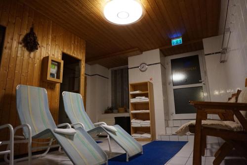a room with two chairs and a table and a window at Avantgarde Hotel in Hattingen