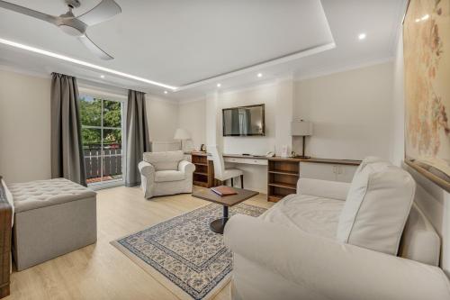 a living room with a couch and a table at ChiemseeStern Vacation & Recreation "Adults Only" in Gstadt am Chiemsee