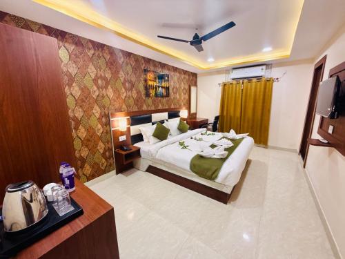 a hotel room with a bed and a television at Hotel Golden Crystal Best Hotel in kankarbagh Patna in Patna