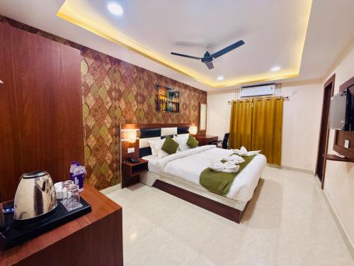 a hotel room with a bed and a television at Hotel Golden Crystal Best Hotel in kankarbagh Patna in Patna