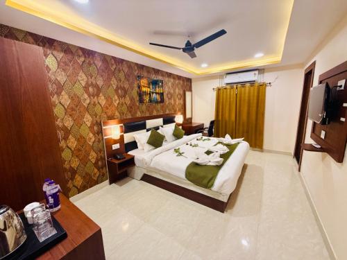 a hotel room with a bed and a television at Hotel Golden Crystal Best Hotel in kankarbagh Patna in Patna