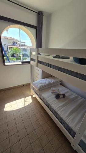 a room with two bunk beds and a window at La Maison de l'ile Bora in Policoro