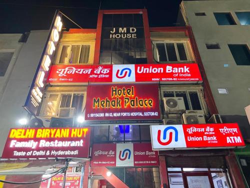 a group of signs on the side of a building at Hotel Mehak Palace By Aura in Noida