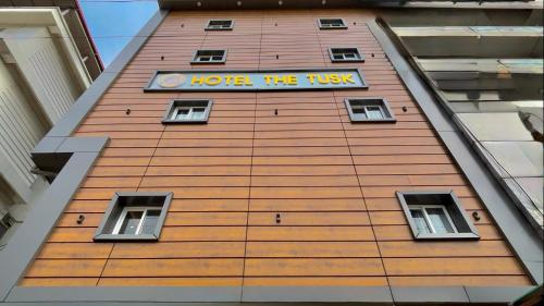 a building with a sign that reads hope the trust at Hotel The Tusk in Rishīkesh