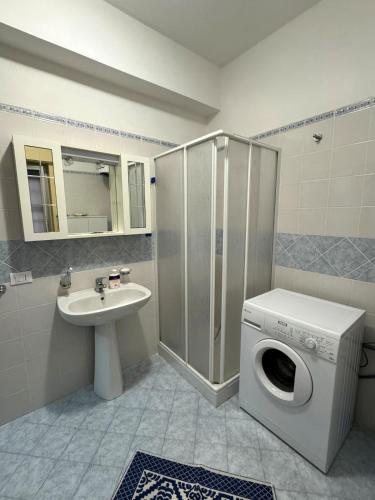 a bathroom with a washing machine and a sink at Oasi di Tindari in Oliveri