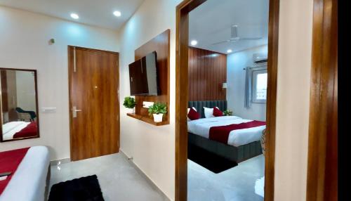a hotel room with a bed and a television at Hotel The Tusk in Rishīkesh
