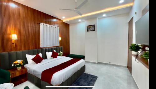 a hotel room with a bed and a couch at Hotel The Tusk in Rishīkesh
