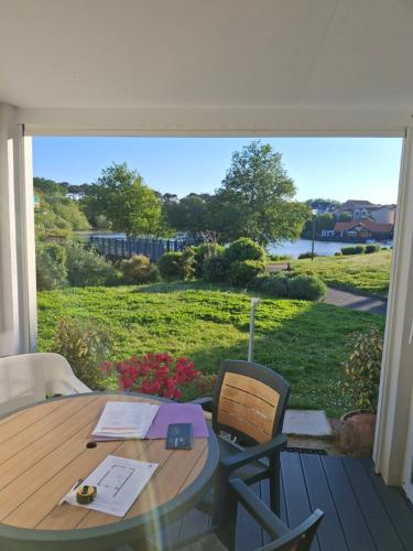 a table and chairs on a porch with a view of a yard at Port Bourgenay in Talmont