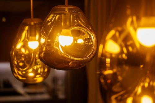 a group of lights hanging from a wall at MOLO LIPNO RESIDENCE in Lipno nad Vltavou