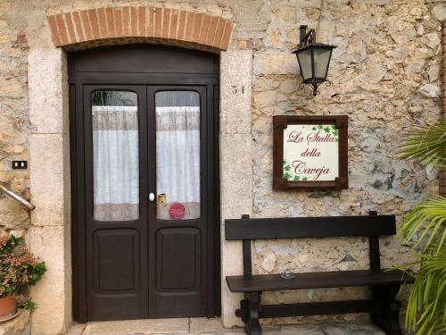 a door to a building with a bench in front at La Caveja in Pietravairano