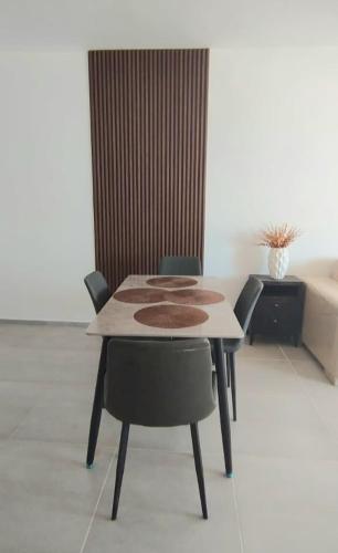 a dining table and chairs in a living room at LagunaSuite & More in Porlamar