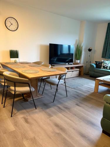 a living room with a table and chairs and a tv at Apartmán Mateřídouška in Cerny Dul
