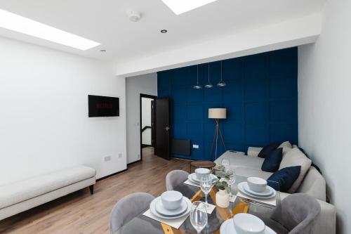 a living room with a couch and a table at Two Bedroom Executive Pad by Traboule Properties Ltd in Warrington