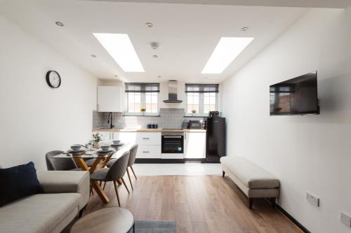 a kitchen and living room with a couch and a table at Two Bedroom Executive Pad by Traboule Properties Ltd in Warrington