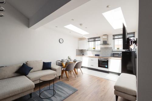 a living room with a couch and a table at Two Bedroom Executive Pad by Traboule Properties Ltd in Warrington
