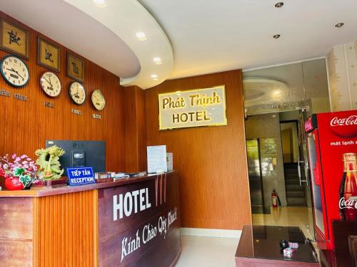a hotel room with clocks on the wall and a counter at Phát Thịnh Hotel in Ho Chi Minh City