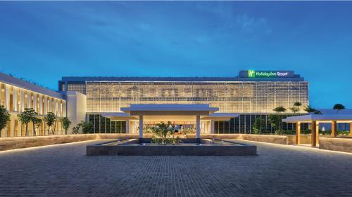 a large building with a fountain in front of it at Holiday Inn Resort Bintan Lagoi Beach by IHG in Lagoi