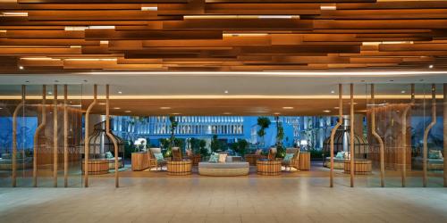 a lobby with couches and chairs in a building at Holiday Inn Resort Bintan Lagoi Beach by IHG in Lagoi