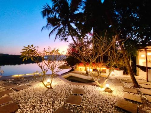 a resort with a view of the water at night at Midsummer Night Dreams in Canacona