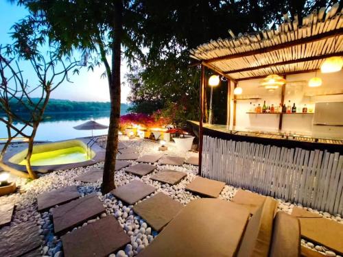 a resort with a bar with a view of the water at Midsummer Night Dreams in Canacona
