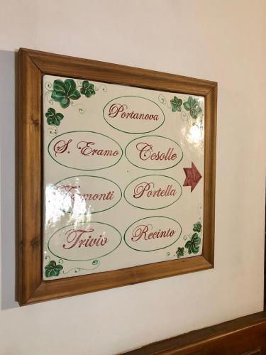 a framed sign on a wall with holly at La Caveja in Pietravairano