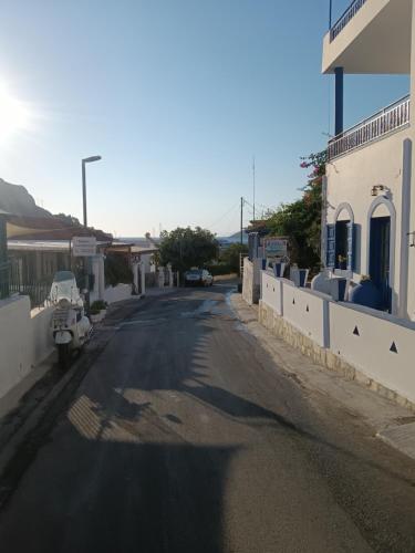 an empty street in a town with a building at Theodore's Mansion Your aristocratic escape in Greece in Panteli