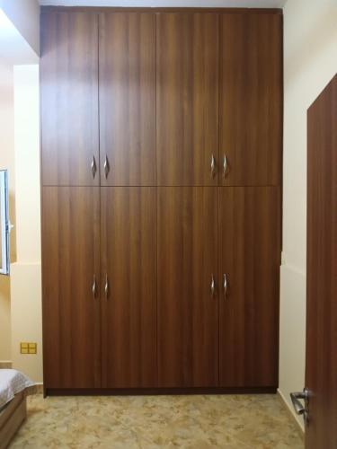 a large wooden wardrobe in a bedroom at Theodore's Mansion Your aristocratic escape in Greece in Panteli