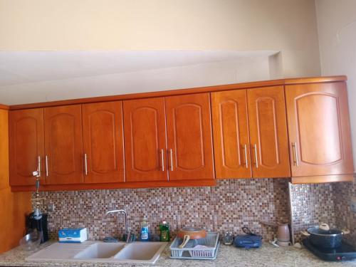 a kitchen with wooden cabinets and a sink at Theodore's Mansion Your aristocratic escape in Greece in Panteli
