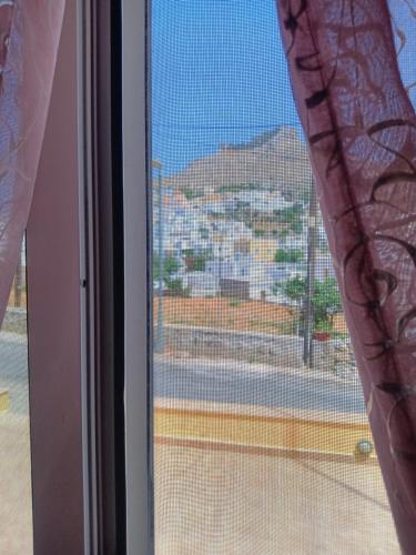 a window with a view of a city at Theodore's Mansion Your aristocratic escape in Greece in Panteli