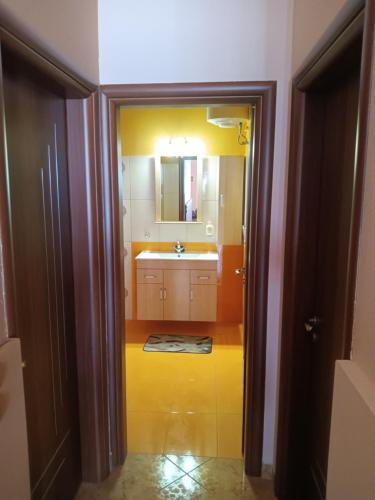 a bathroom with a sink and a mirror at Theodore's Mansion Your aristocratic escape in Greece in Panteli